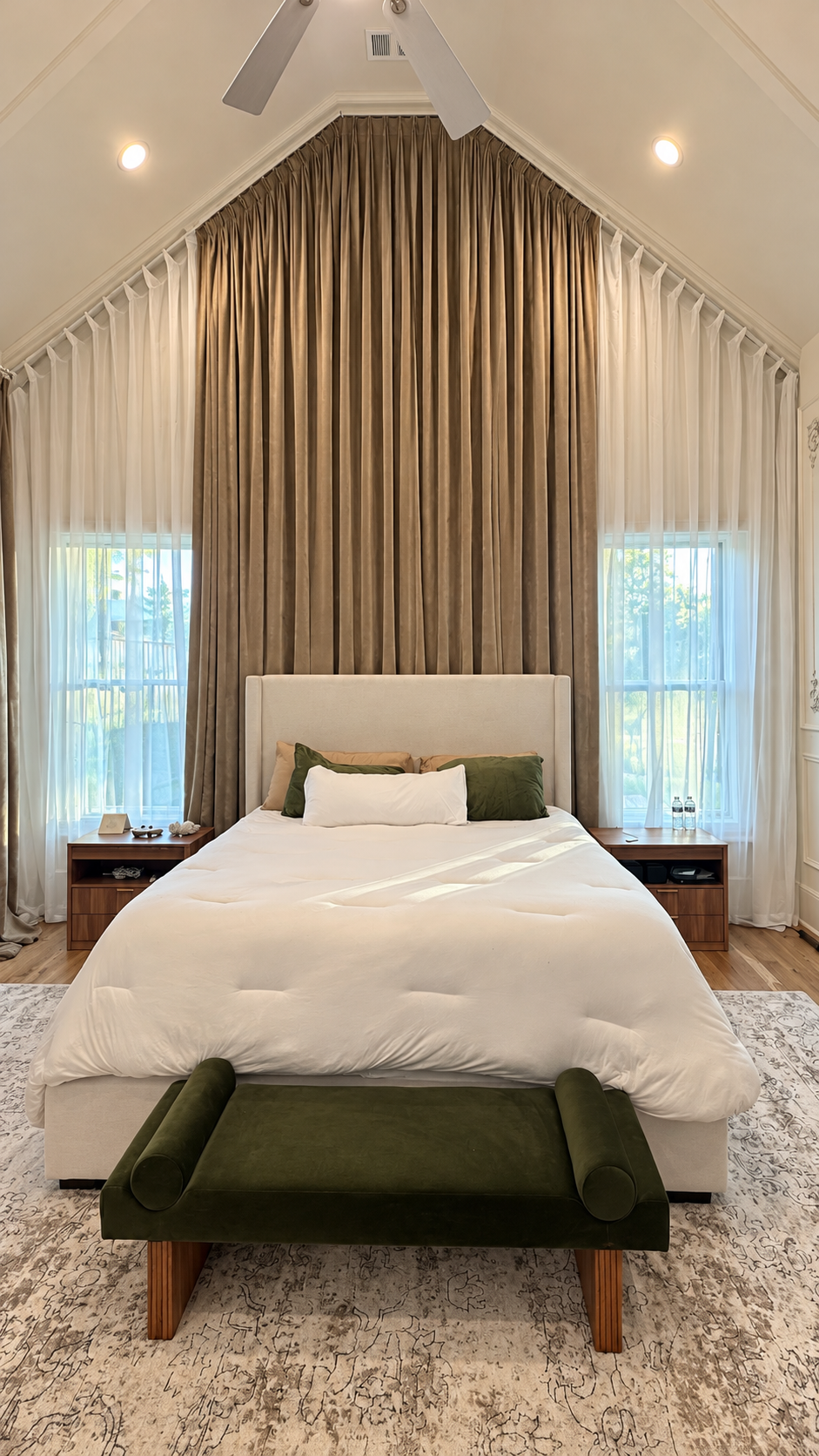 Audubon Suite king bed beneath the vaulted curtain wall