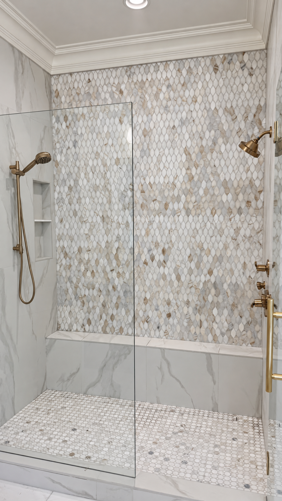 Audubon Suite marble walk-in shower with mosaic wall and brass fixtures