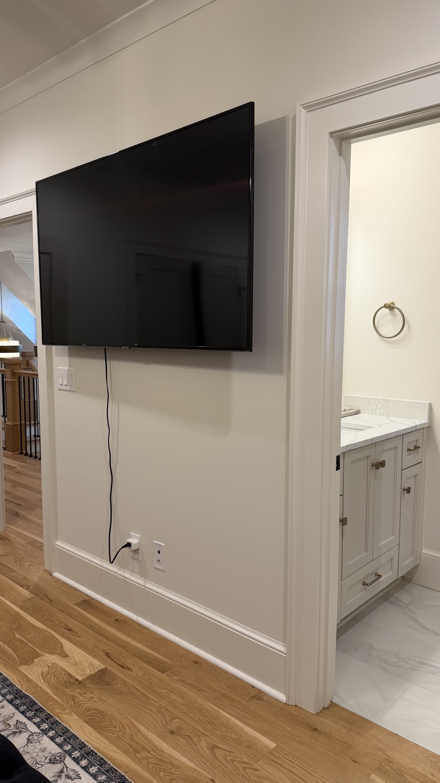 The Clubhouse Suite television and bathroom entrance