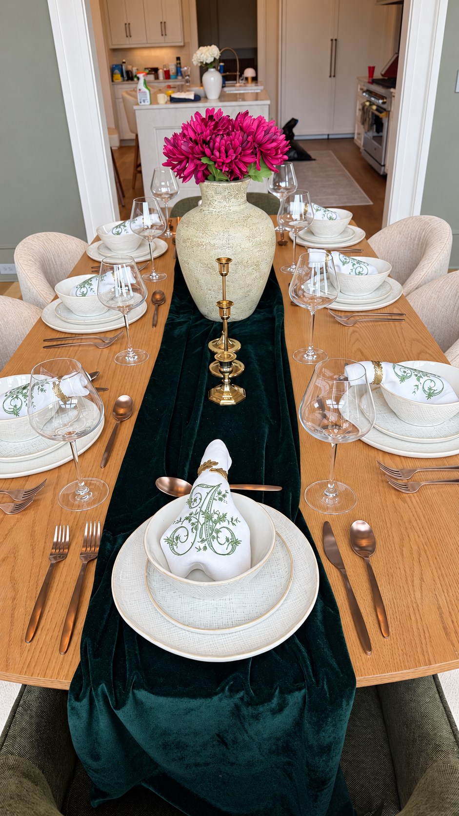 Fully set dining table viewed toward the kitchen