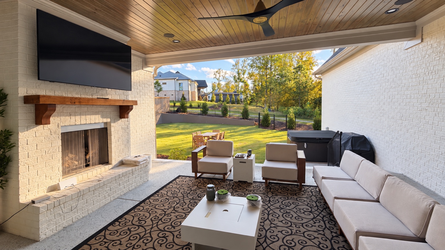 Covered patio lounge with fireplace and television