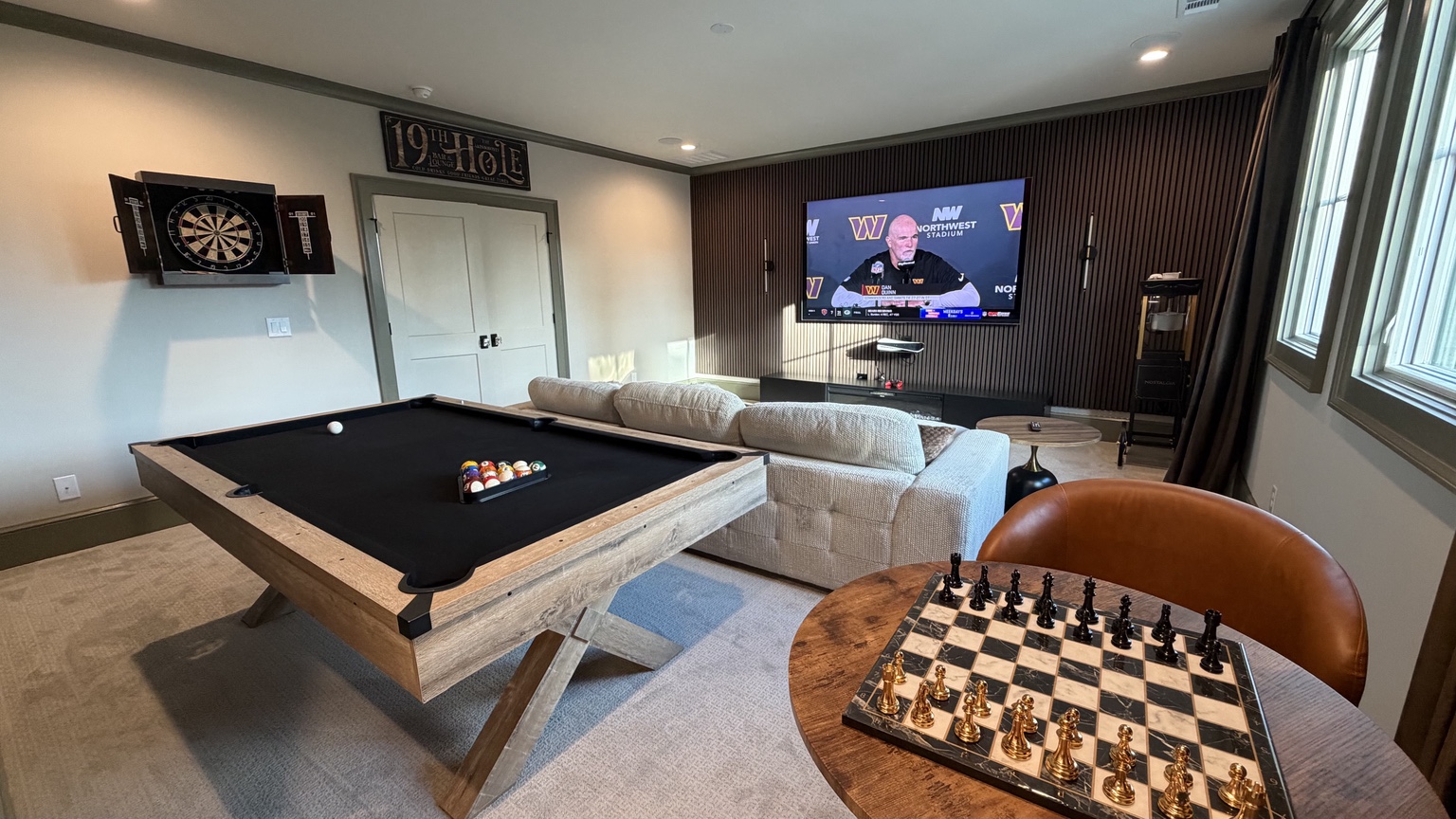 The 19th Hole game room with pool table and sectional