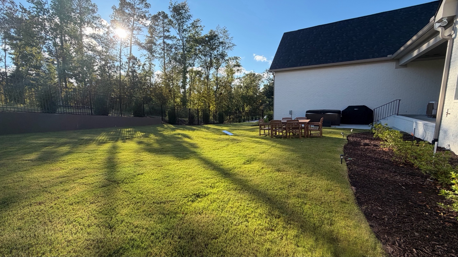 Landscaped backyard lawn beside the residence