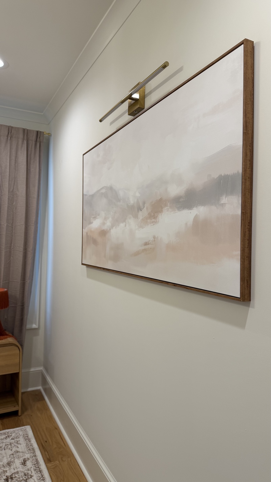 Neutral artwork and picture light in The Georgia Peach