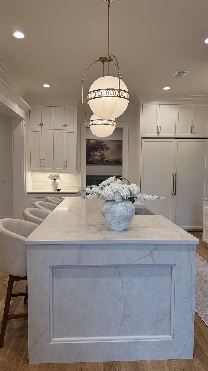 Kitchen island viewed from the end with floral arrangement
