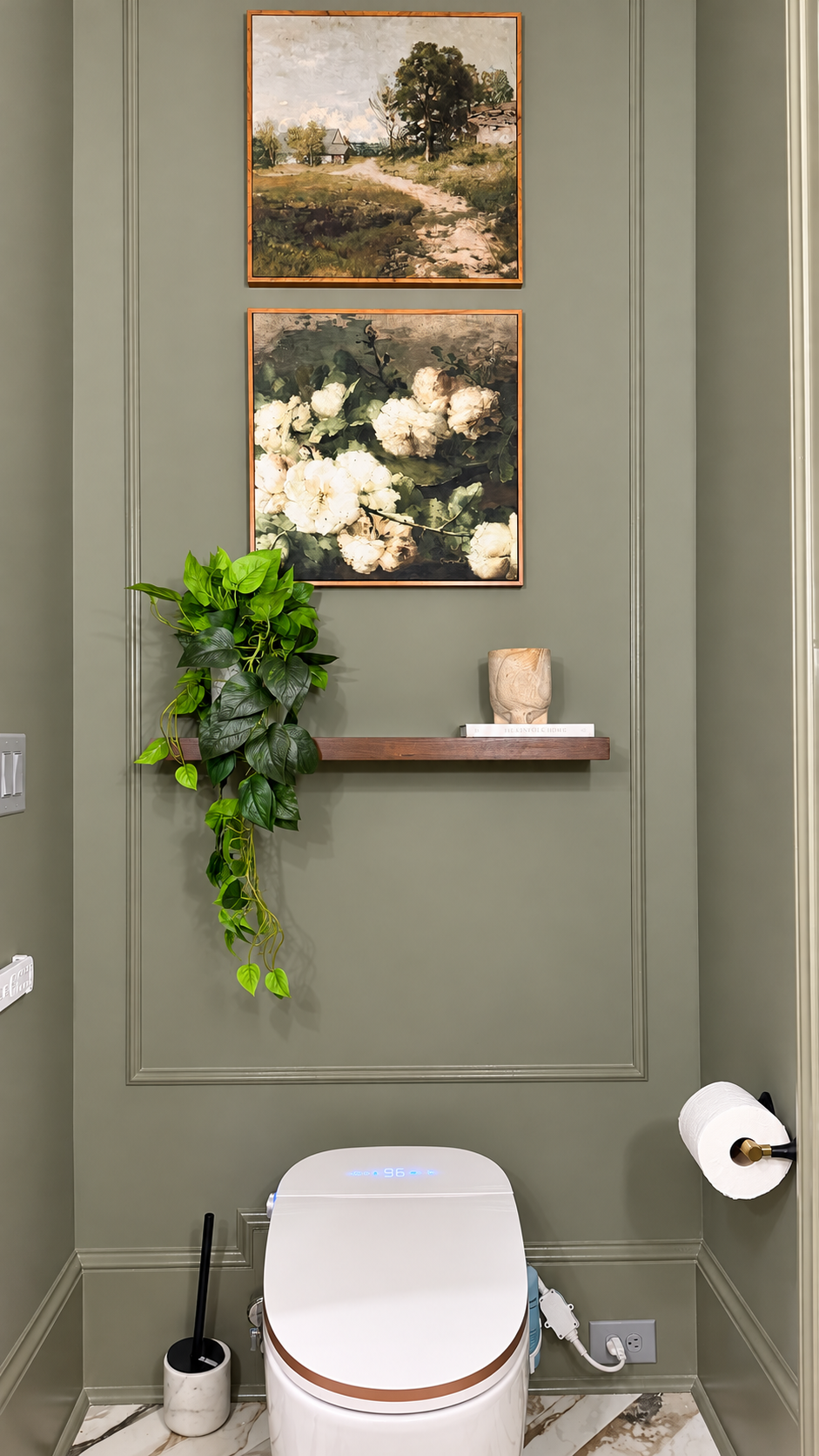 Olive powder room with smart toilet, artwork and floating shelf