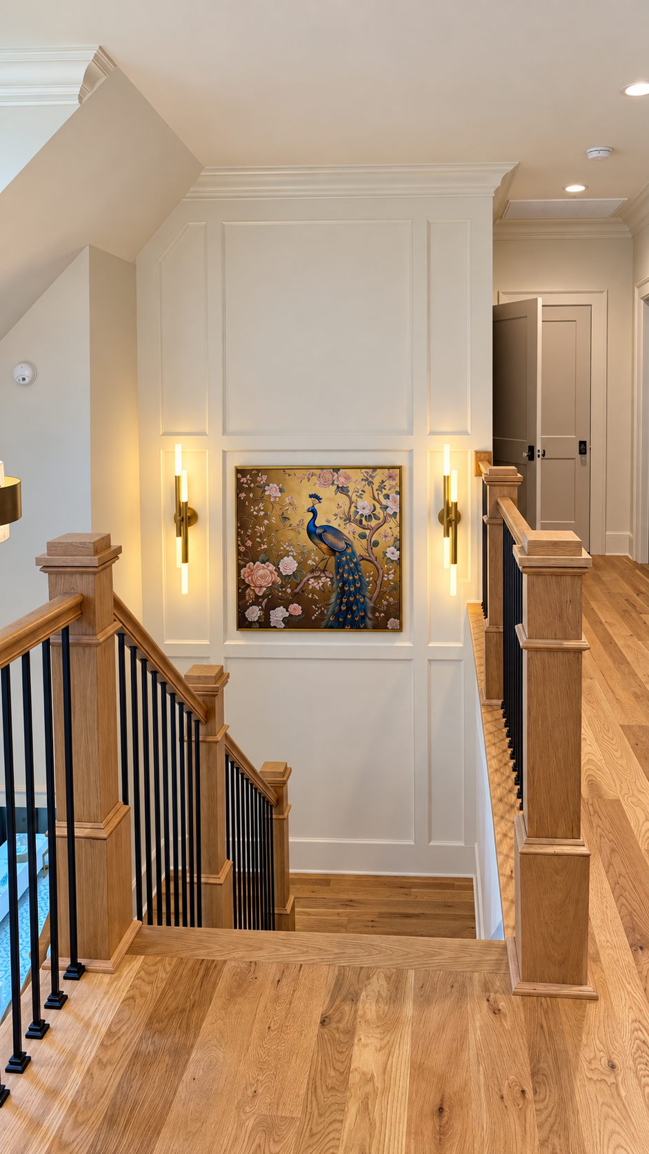 Upper landing and staircase with illuminated peacock artwork