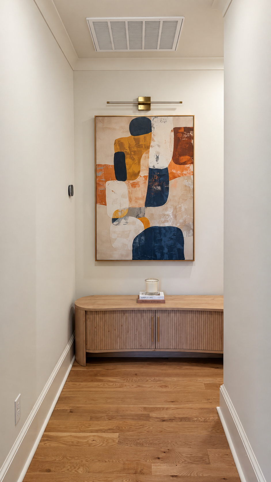 Upstairs hallway console beneath abstract artwork
